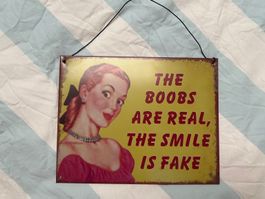 Metall Schild ' The Boobs are Real, the Smile is Fake '