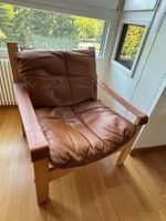 Sessel aus Holz mit braunem Lederbezug gebrauchter Zustand