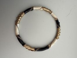 Armreif schwarz weiss mit Golddekor gebraucht