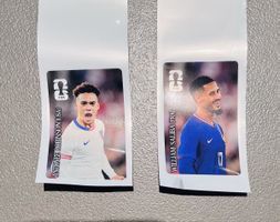 2er Set, Panini WM 26, Coca Cola Robinson (USA) Saliba (FRA)