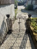 Wrought iron garden gate with planters, antique style