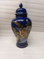 Cobalt blue porcelain vase with gold and polychrome details.
