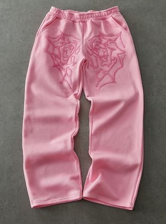 Pantalon de jogging gris avec roses brodées.