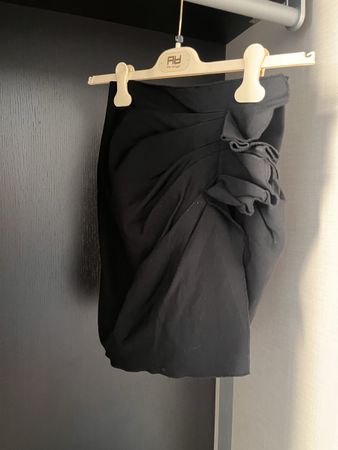 Minigonna nera drappeggiata con volant – aderente