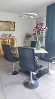 Moderner schwarzer Glastisch mit 4 eleganten Designerstühlen