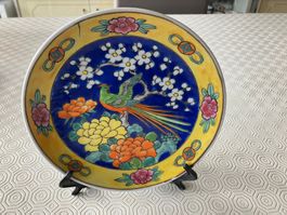 Piatto da collezione asiatico con volatile