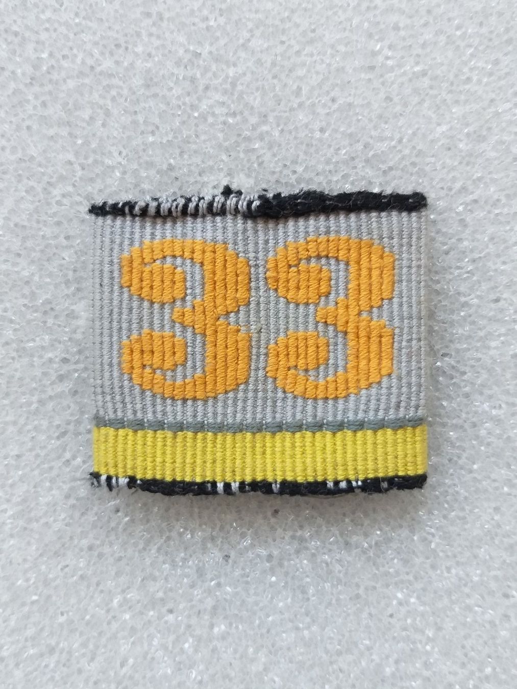 Placchette & Badge: Achselschlaufe Übermittlung Bat 33 Kp 3 – Usato da Bauma venduto da SwissMilitaria