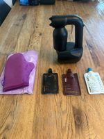 Spray-Tan-Gerät mit Bräunungsprodukten und Handschuh