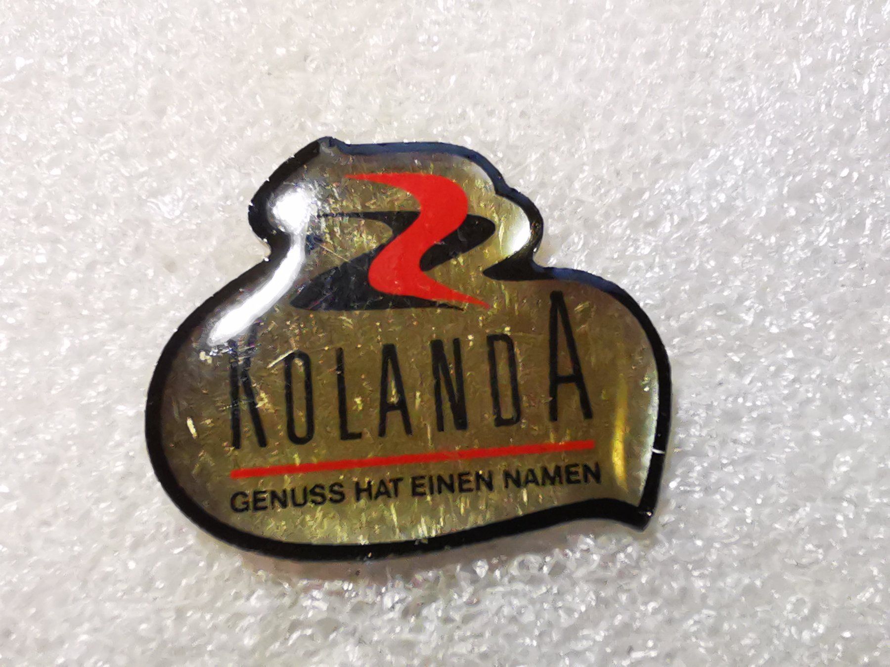Plaketten & Abzeichen: Ansteckpin 71: Kolanda – Gebraucht aus Oppligen von Pin-Fall-Shop
