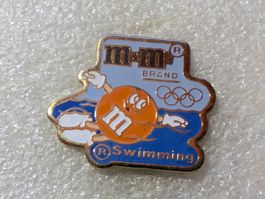 Ansteckpin 108: Olympia x m&m's