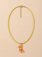 Yellow chain necklace with orange teddy bear pendant