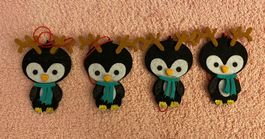 4 Pinguine mit Rentiergewihen