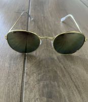 SONNENBRILLE MIT GOLDENER FASSUNG UNGETRAGEN
