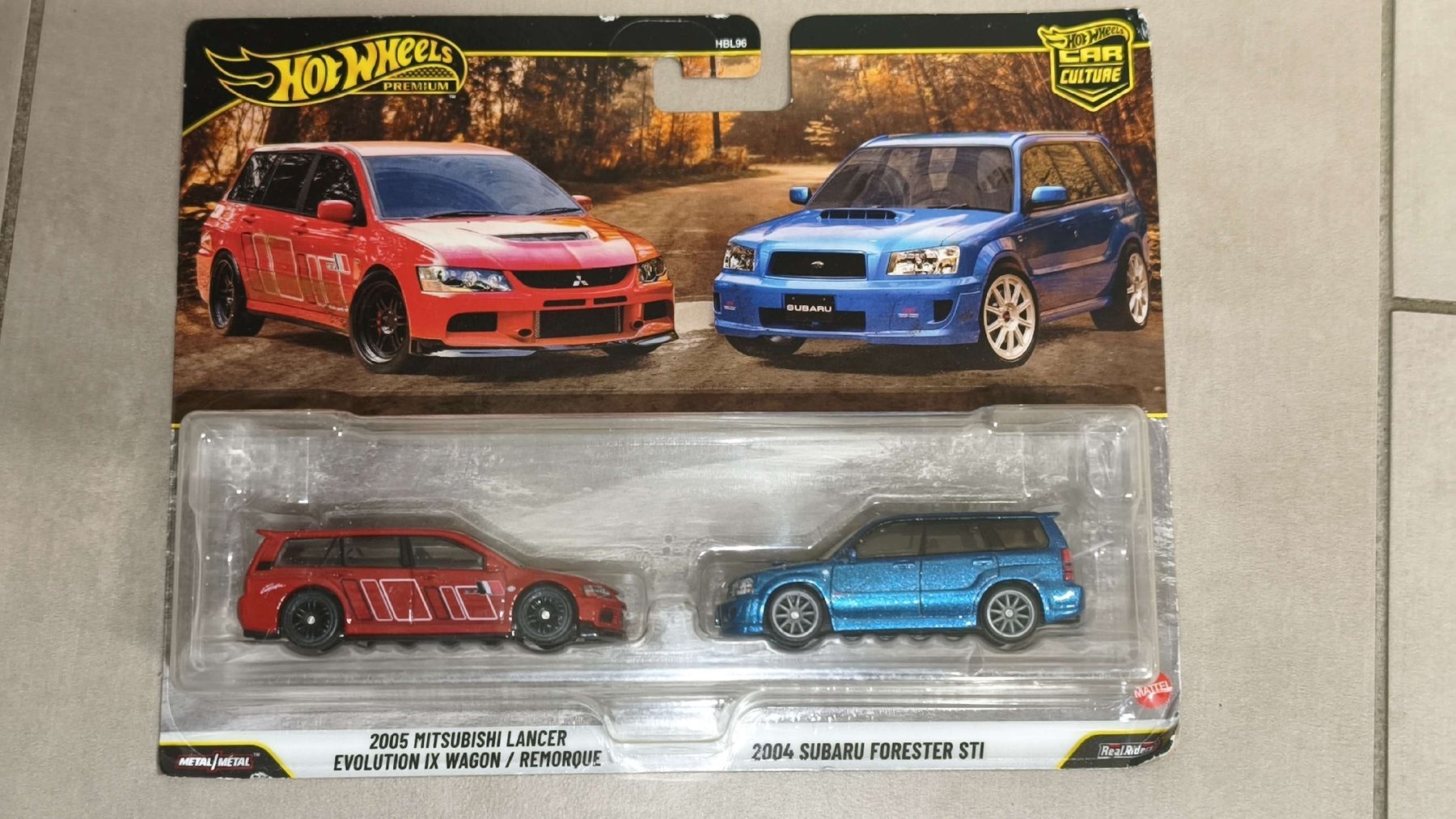 Hot Wheels Modellini d'auto: Hot Wheels Premium Subaru Forester STI & Lancer Evolution IX – Nuovo e nell'imballaggio originale da Uster venduto da Vega56