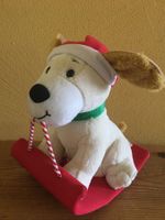 Hund schaukelt und singt Jingle Bells