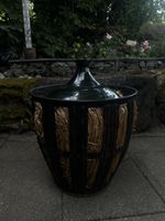 Large glass demijohn bottle with basket, dark green