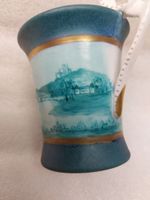 Porcelain cup with a landscape painting