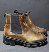 Golden bronze boots