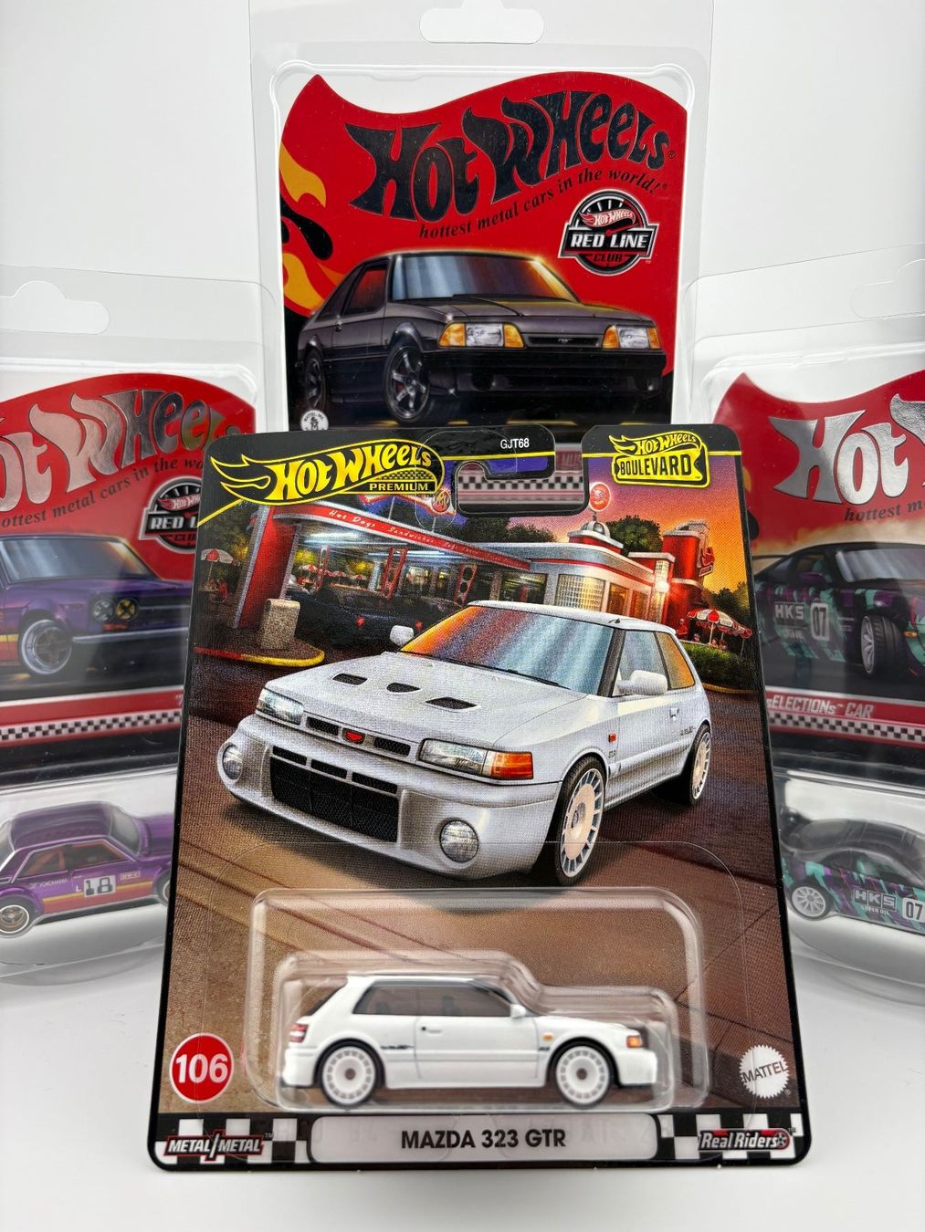 Hot Wheels Modellini d'auto: Hot Wheels Mazda 323 GTR Premium Boulevard #106 – Nuovo e nell'imballaggio originale da Flawil venduto da HeisseReifen