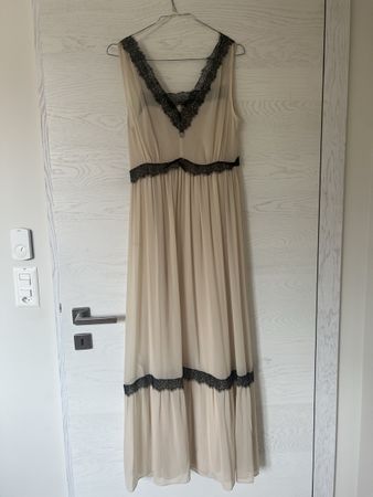 Elegant cream maxi dress with black lace detail.