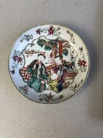A set of Chinese enamel cups and saucers from the Qianlong