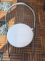 Folding chair metal frame white seat.