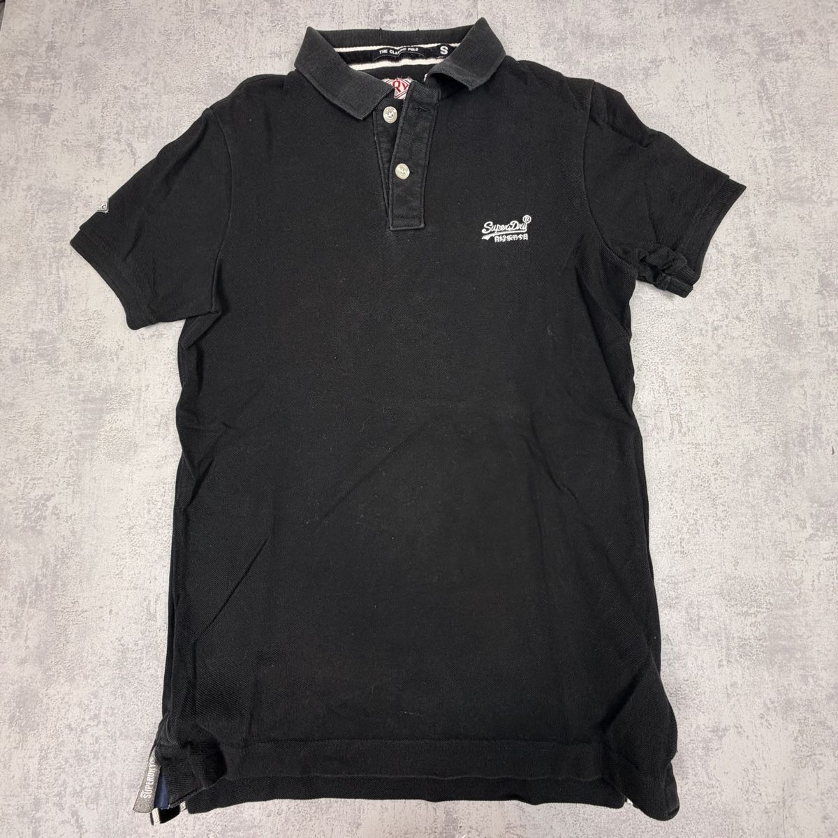 Superdry Magliette Polo: Polo SuperDry noir - Taille S  – Nuovo (secondo la descrizione) da Neuchâtel venduto da aliceguins