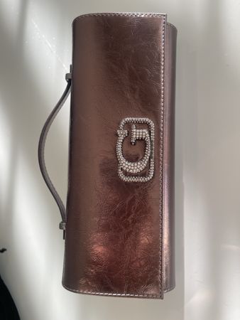 Beautiful metallic evening bag with crystal logo