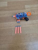 X-Shot gun with darts and graffiti design