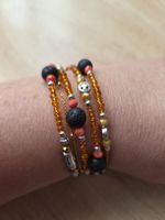 Spiral Armband Orange mit Smeily und Lavastein Neu