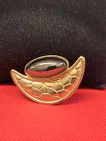Brosche goldfarben mit dunklem Stein in Mondform gebraucht