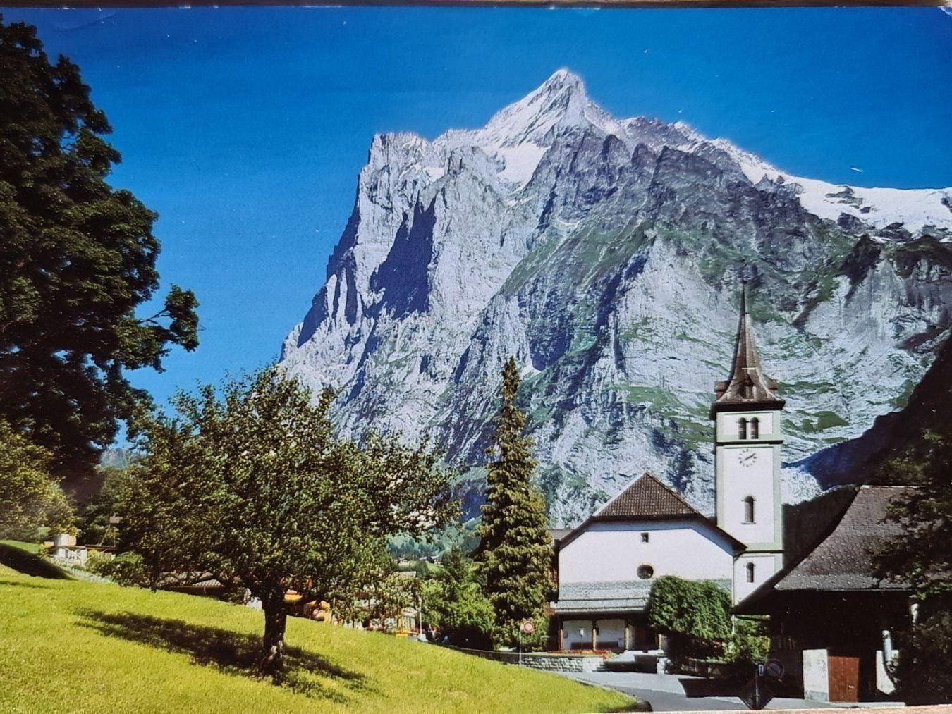 Cartoline postali: Ansichtskarte Grindelwald Kirche, Wetterhorn 1990 – Usato da Dintikon venduto da Vexi