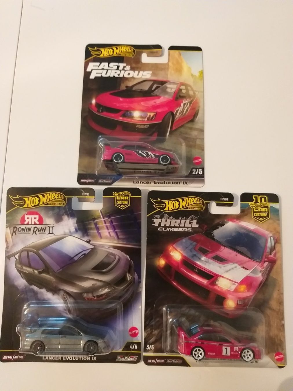 Mitsubishi Modellini d'auto: Hot Wheels 3 Mitsubishi Premium Lancer Evo Set – Nuovo e nell'imballaggio originale da Brugg AG venduto da Evilweevil
