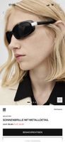 Schicke, schwarze Sonnenbrille mit Metalldetail zu verkaufen