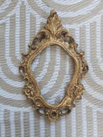 Golden vintage photo frame, oval, ornate, Baroque style
