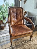 Vintage Ledersessel mit vier Messingrollen