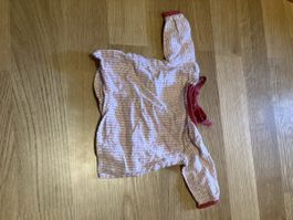 Striped dolls shirt with bow and buttons .