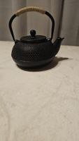 Théière en fonte avec infuseur intégré