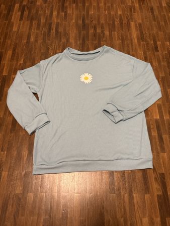 Pullover hellblau mit Gänseblümchenprint Grösse S