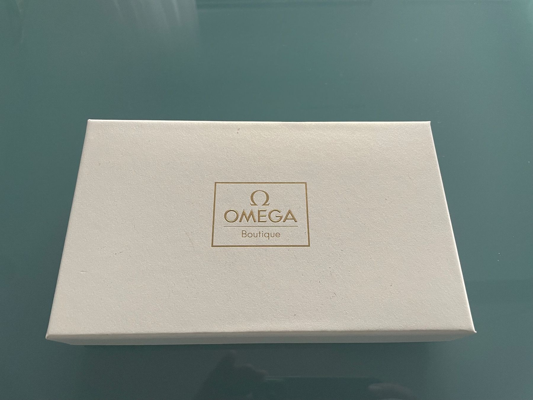 Portamonete: OMEGA Brieftasche, Braun/Orange – Nuovo e nell'imballaggio originale da Zuzwil SG venduto da Skotm