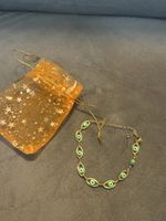 Armband goldfarben mit grünen Augen Neuwertiger Zustand