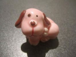 Hund rosa sitzend