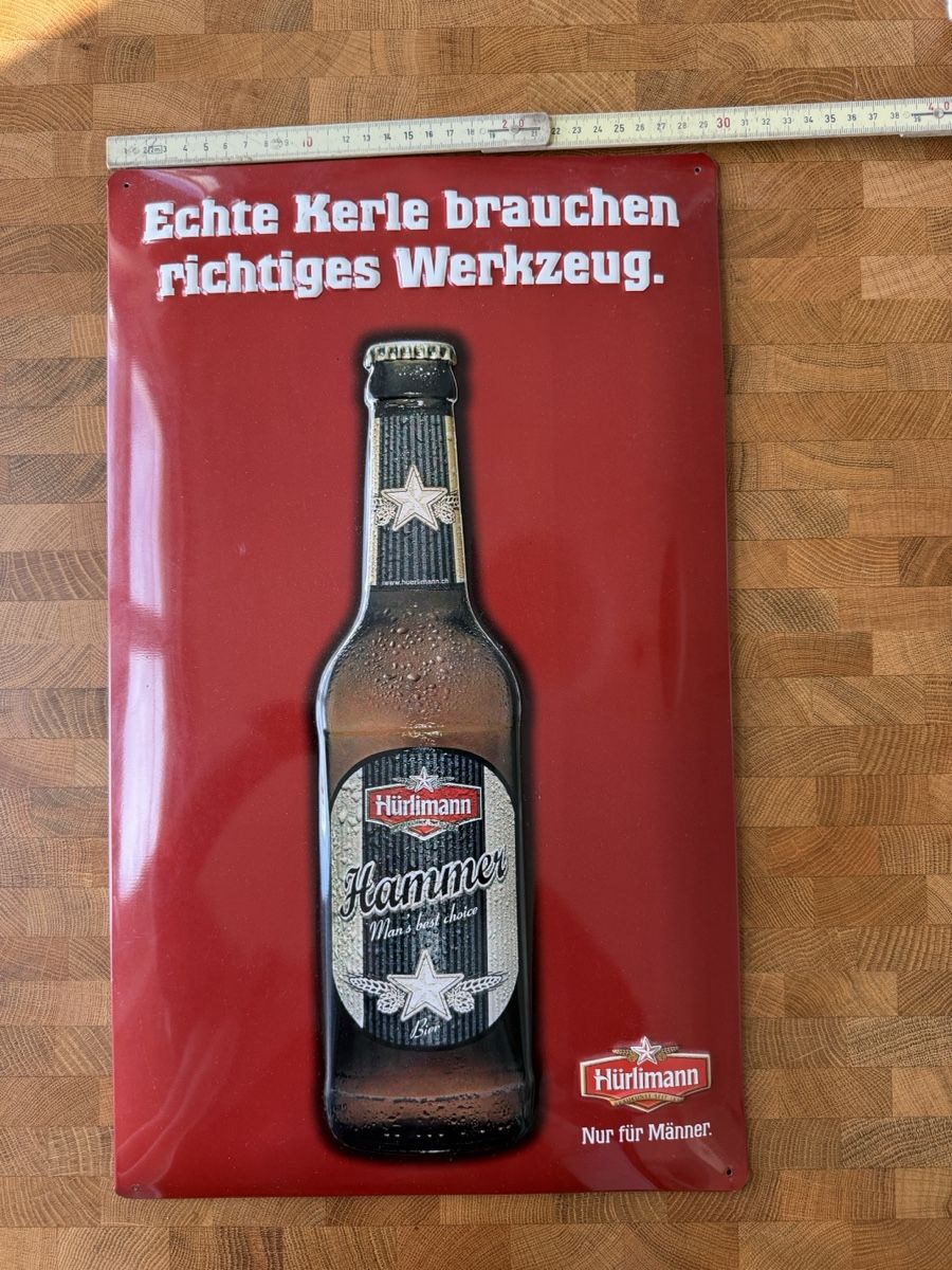Hürlimann Insegne: Hürlimann Hammer - Blechschild - Echte Männer brauchen... – Usato da Bremgarten AG venduto da moreman