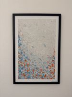 Strukturiertes Bild in orange-blau Tönen und schwarzem Rahme