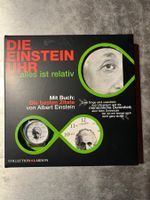 uhr, einstein mit büchlein