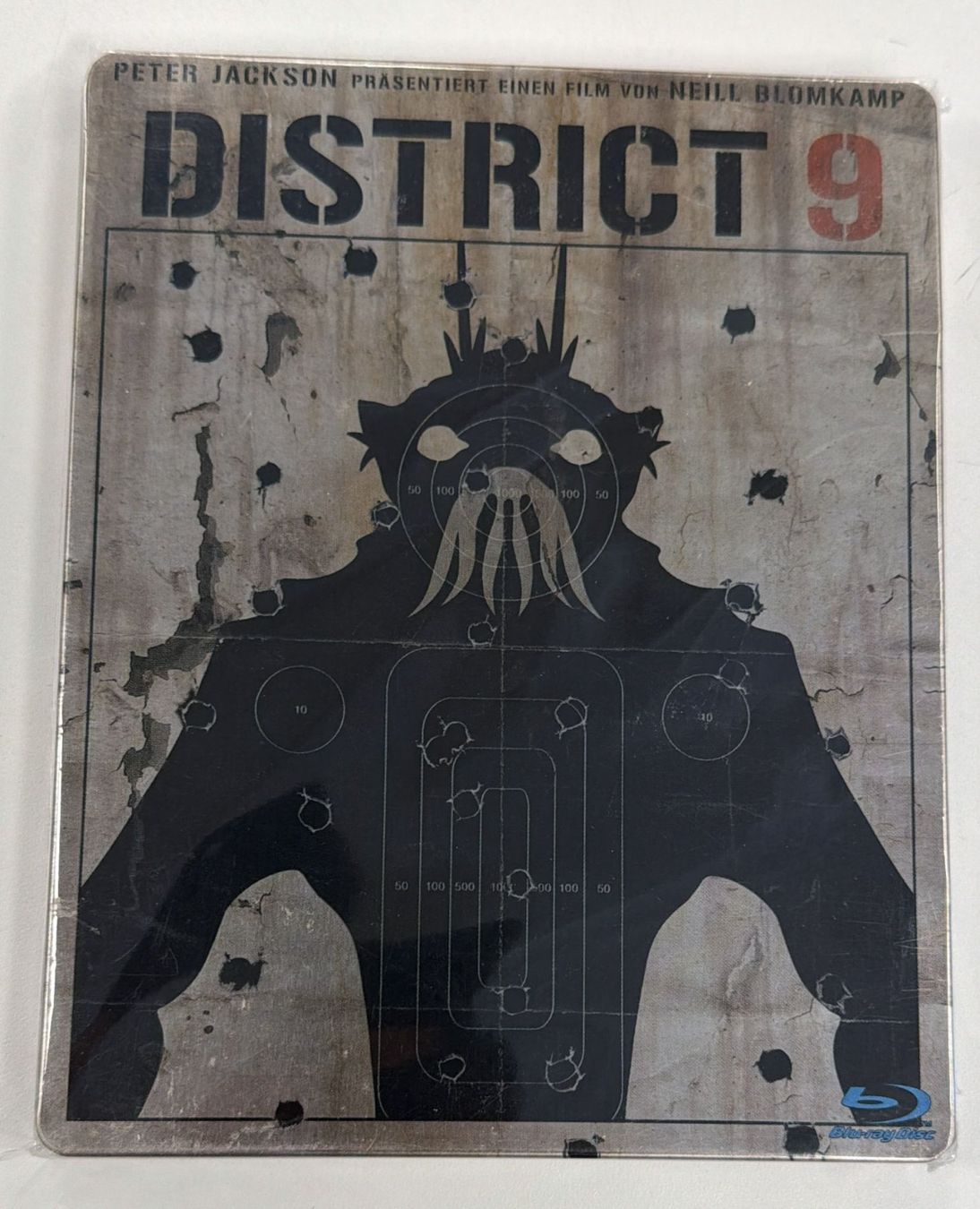 Tutti i DVDs: DISTRICT 9 STEELBOOK BLU -RAY – Nuovo e nell'imballaggio originale da Zürich venduto da freioccasionen