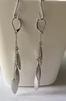 Silver tone dangle earrings leaf design