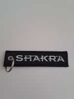 Schlüsselanhänger Shakra Band Logo schwarz gestickt beids.