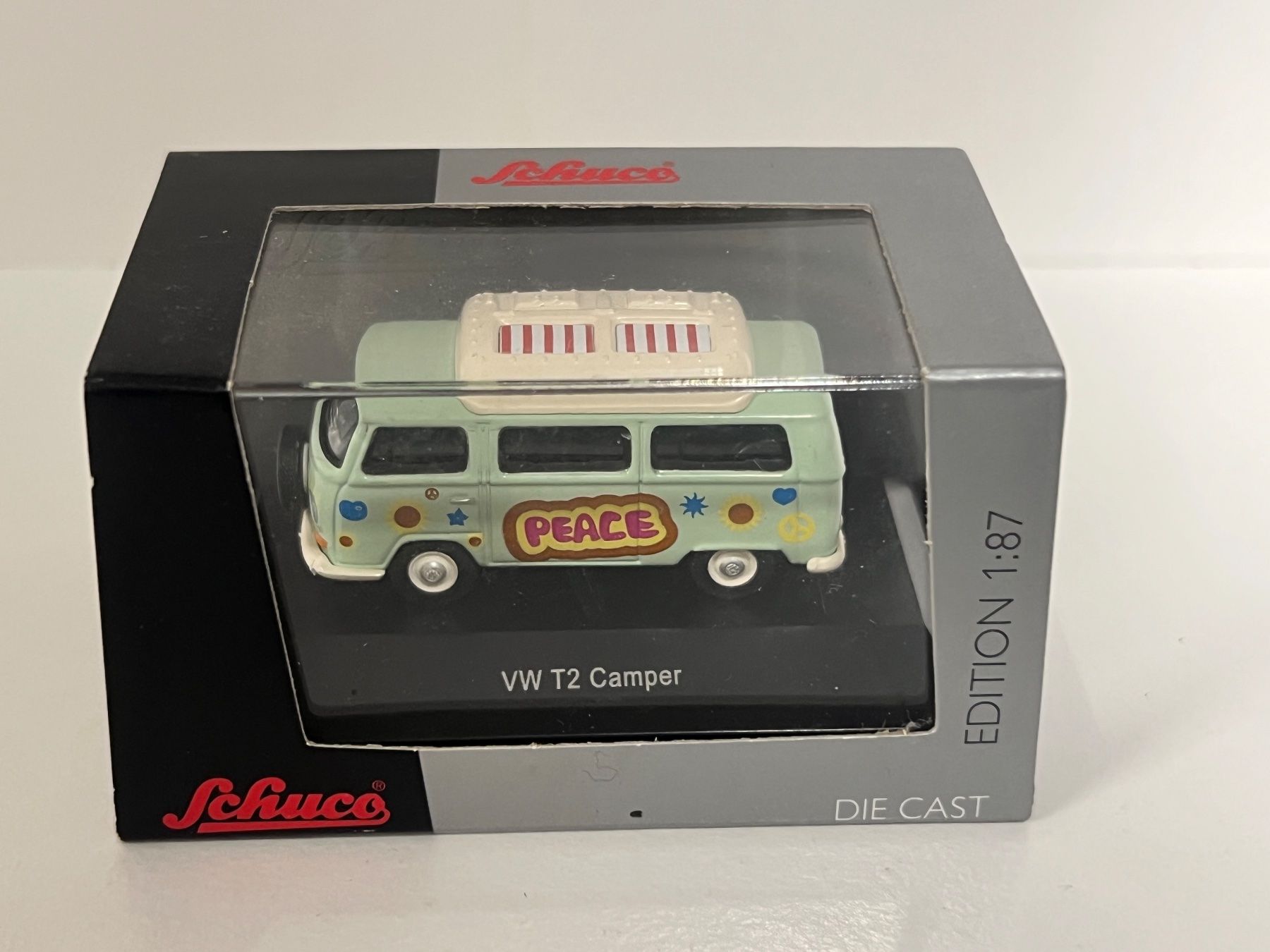 Schuco Modellini di ferrovie: Schuco VW T2 Camper "Peace" Edition 1:87 – Nuovo e nell'imballaggio originale da Geroldswil venduto da TopTrain54