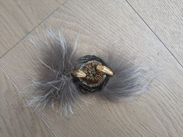 Exquisite vintage brooch with golden snakes and gray fur